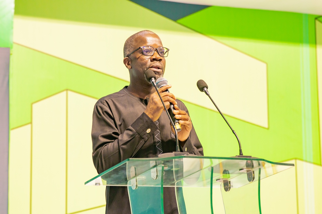 A speaker addressing the hall from the REMA 2025 podium